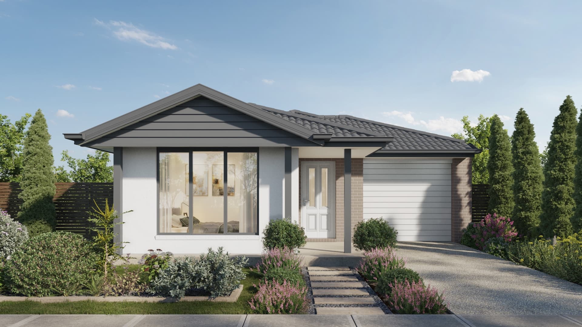 Modern single-story house with a dark gray roof, white and brick exterior, large front window, white door, and attached garage. Neatly landscaped front yard with shrubs and flowers, under a clear blue sky.